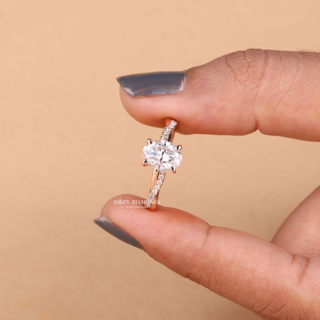 Lifestyle shot of oval solitaire diamond ring on hand