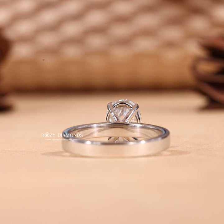 Oval cut engagement ring shown with authenticity certificate