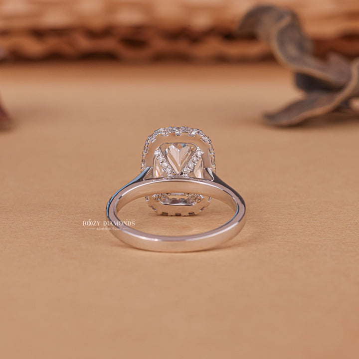 Cushion halo engagement ring close-up showing E/VS1 diamond clarity