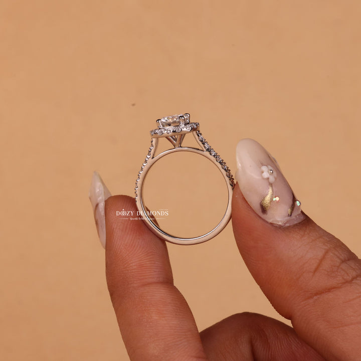 Round halo engagement ring viewed from the side
