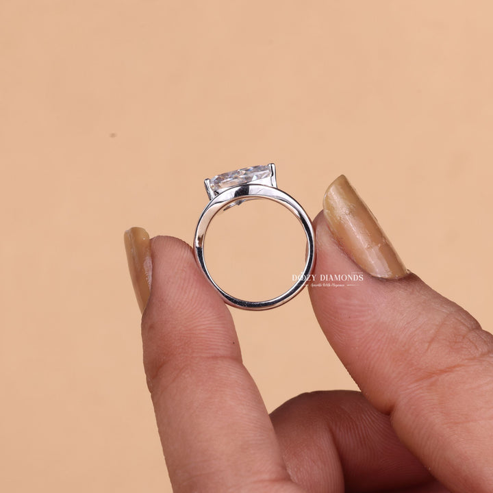 Pear solitaire engagement ring close-up showing F/VS1 diamond clarity