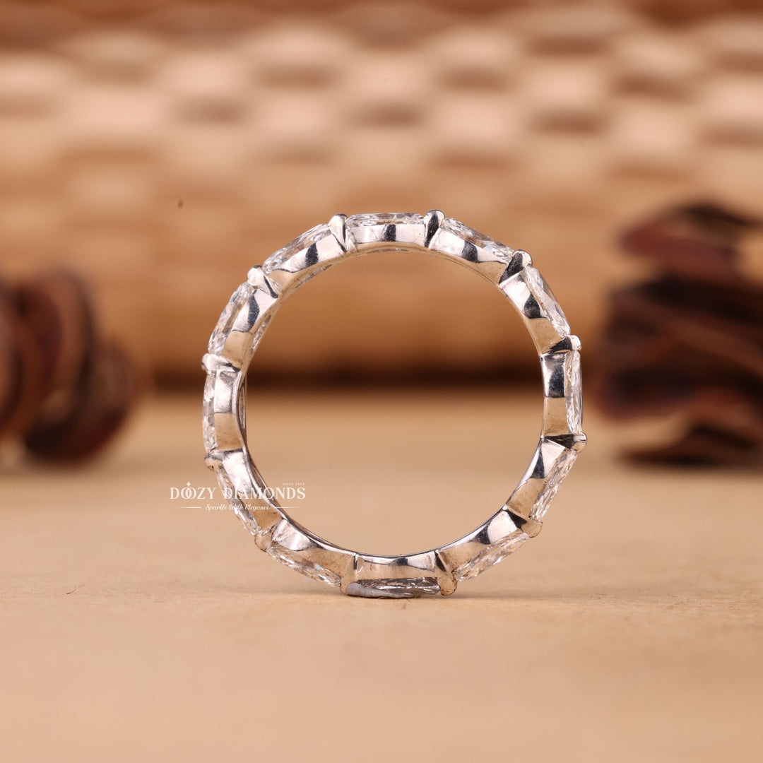 Pear diamond band stacked with engagement ring