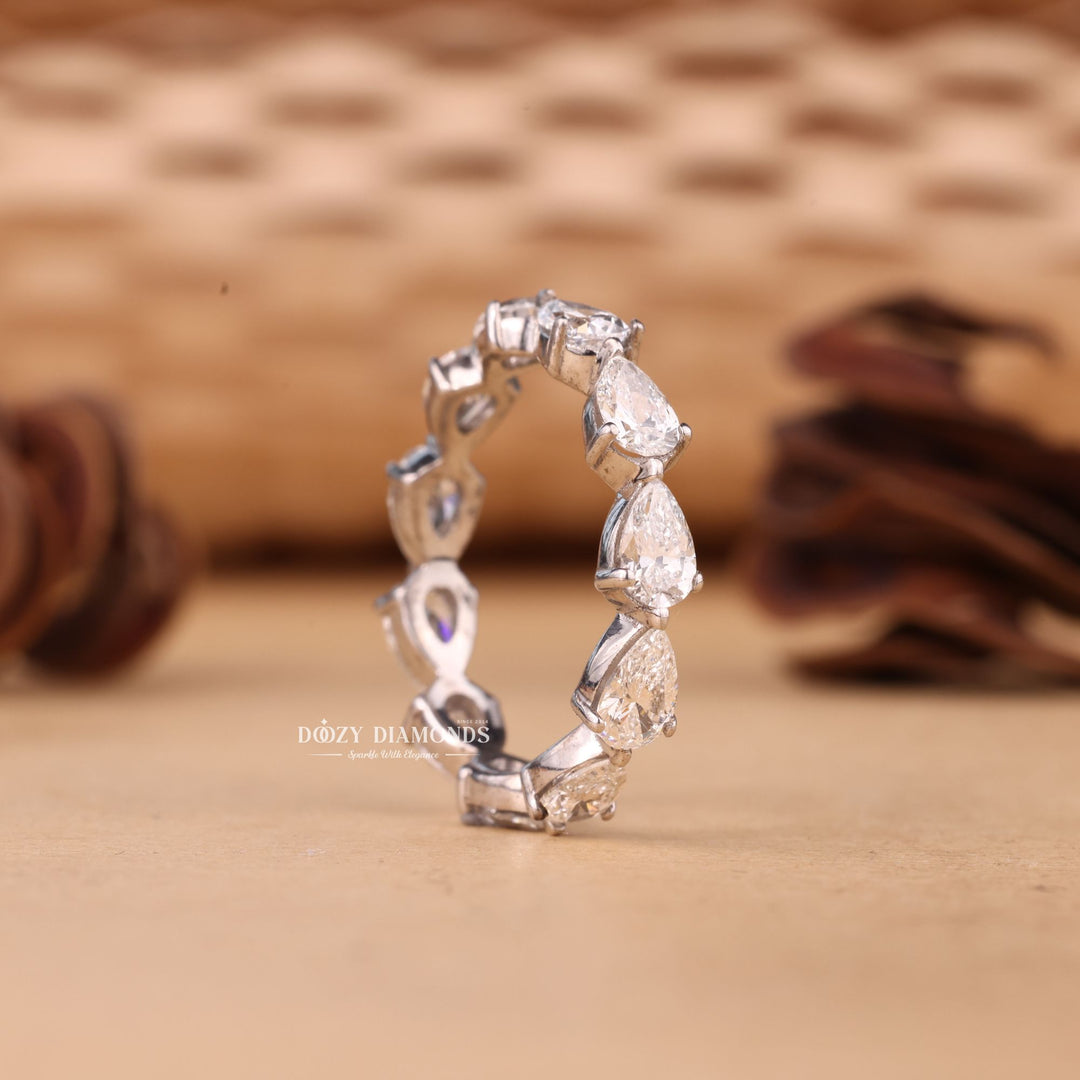 Pear diamond band stacked with engagement ring