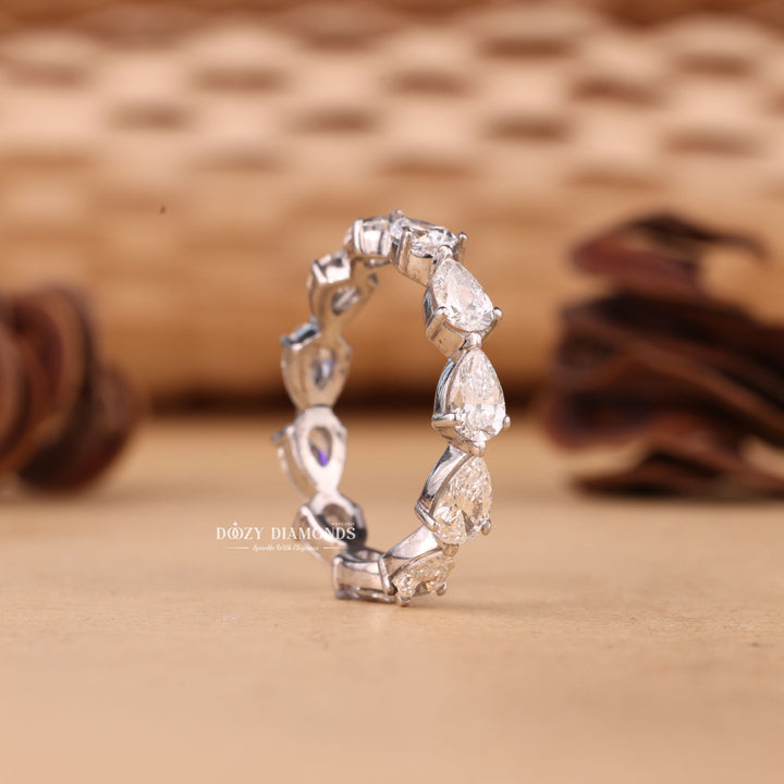 Pear diamond band stacked with engagement ring