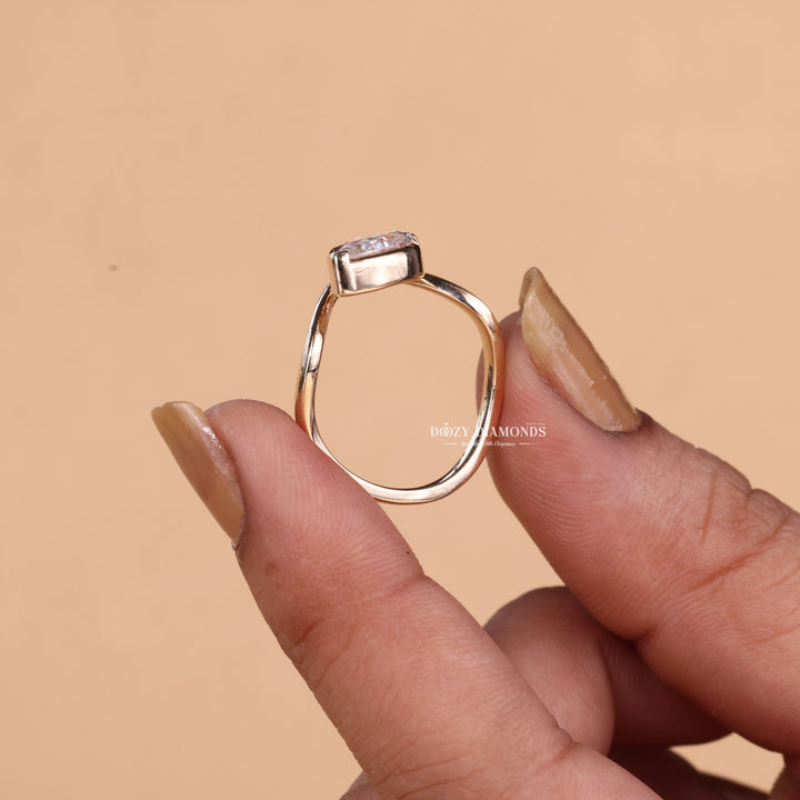 Unboxing view of marquise cut bezel diamond engagement ring
