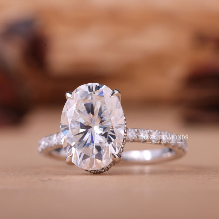 Oval hidden halo engagement ring close-up showing E/VS1 diamond clarity