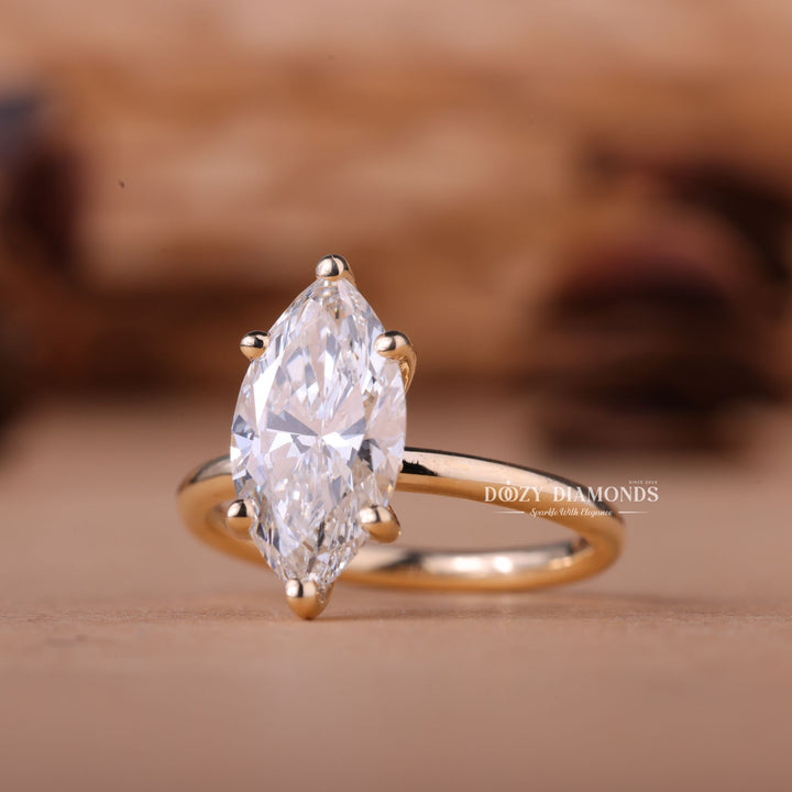 Marquise solitaire engagement ring finished in polished solid gold
