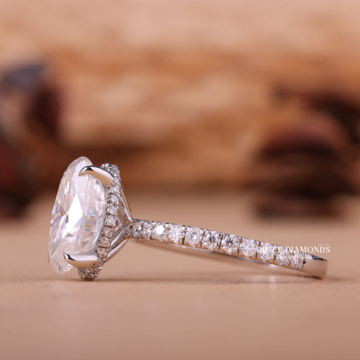 Oval hidden halo engagement ring close-up highlighting diamond sparkle