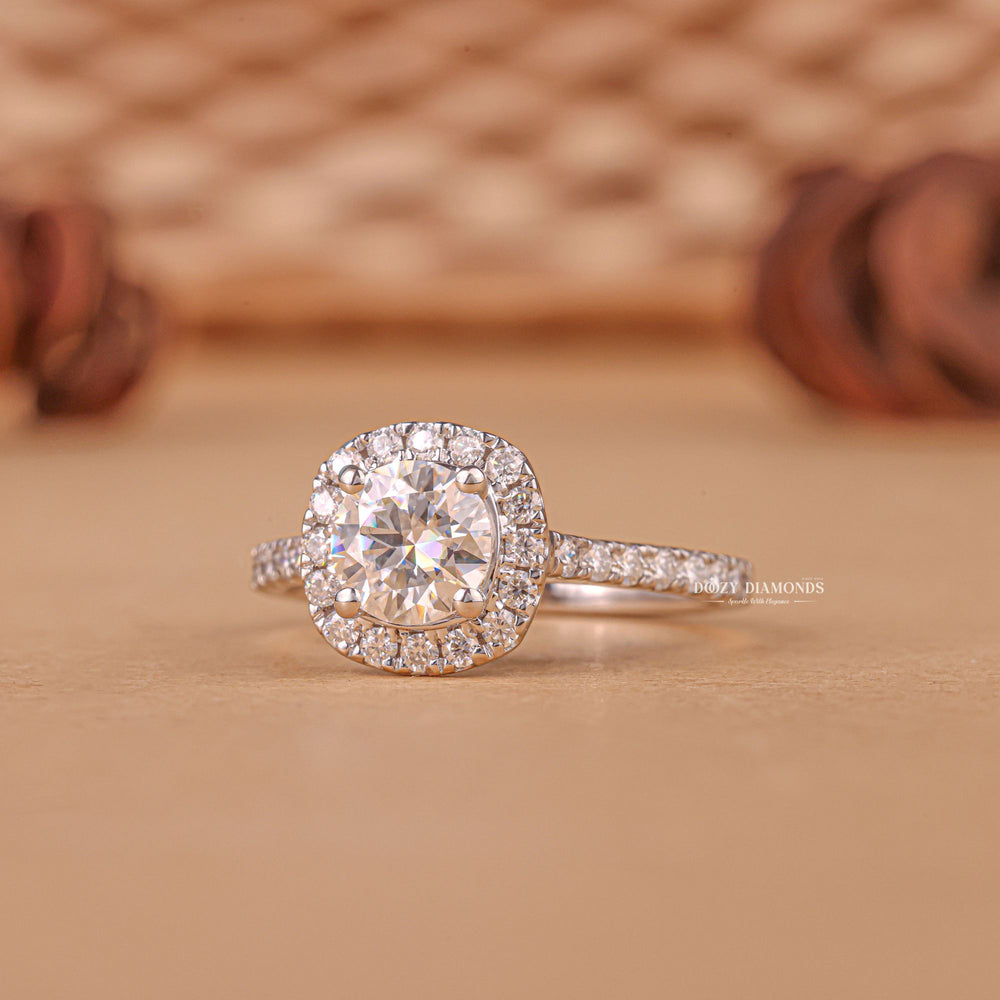 Close-up of round cut center diamond in halo engagement ring