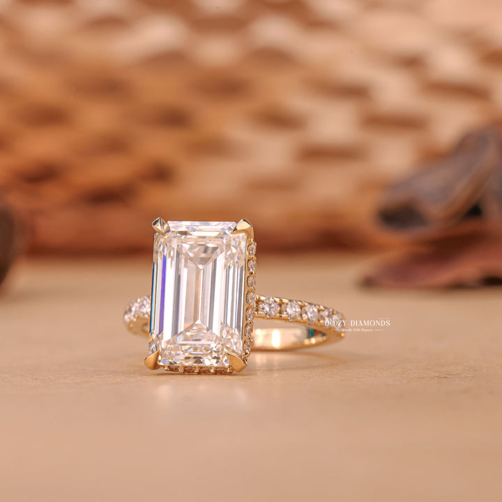 Emerald hidden halo engagement ring viewed from the side