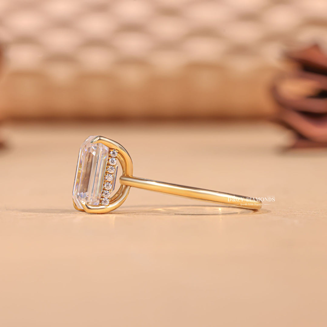 Emerald cut engagement ring shown with authenticity certificate