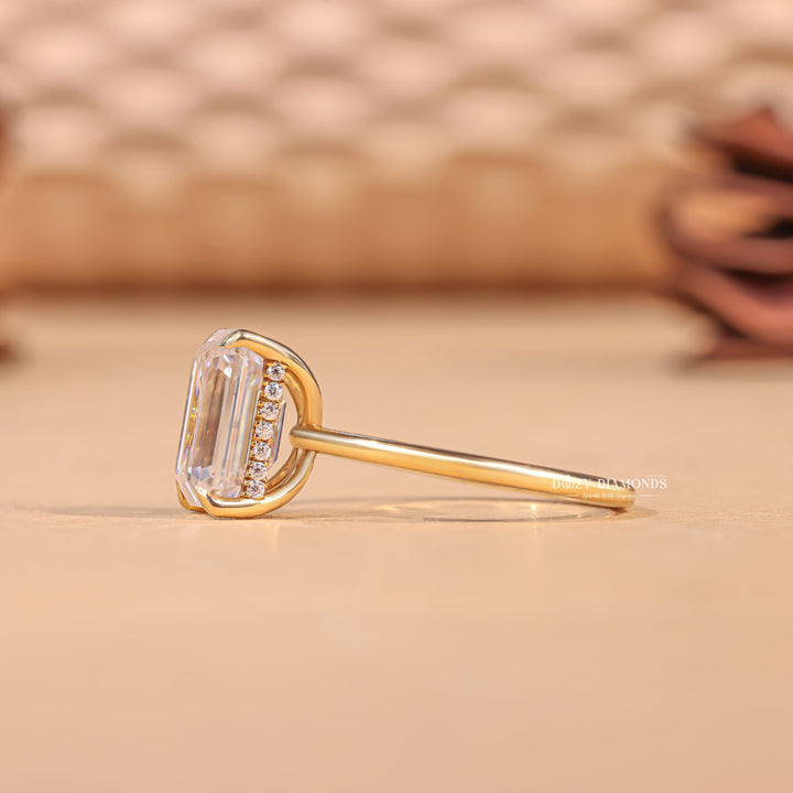 Emerald cut engagement ring shown with authenticity certificate