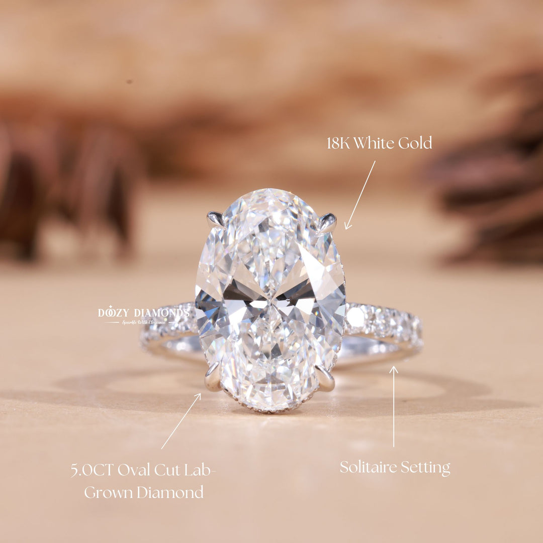Oval hidden halo engagement ring offered in gold and platinum