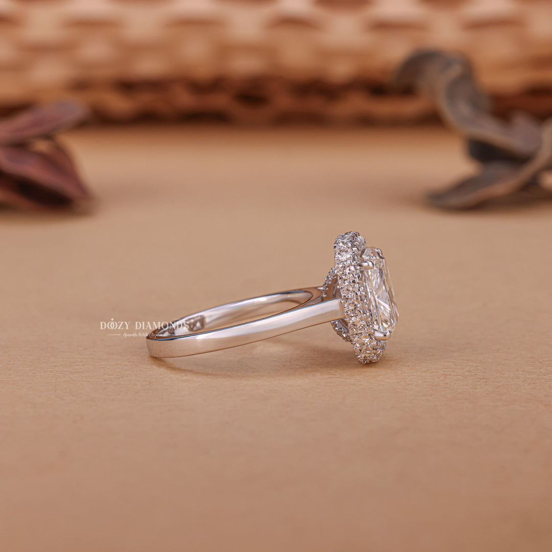 Close-up of cushion cut center diamond in halo engagement ring