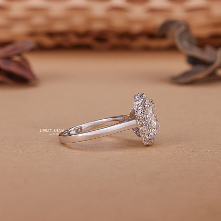 Close-up of cushion cut center diamond in halo engagement ring