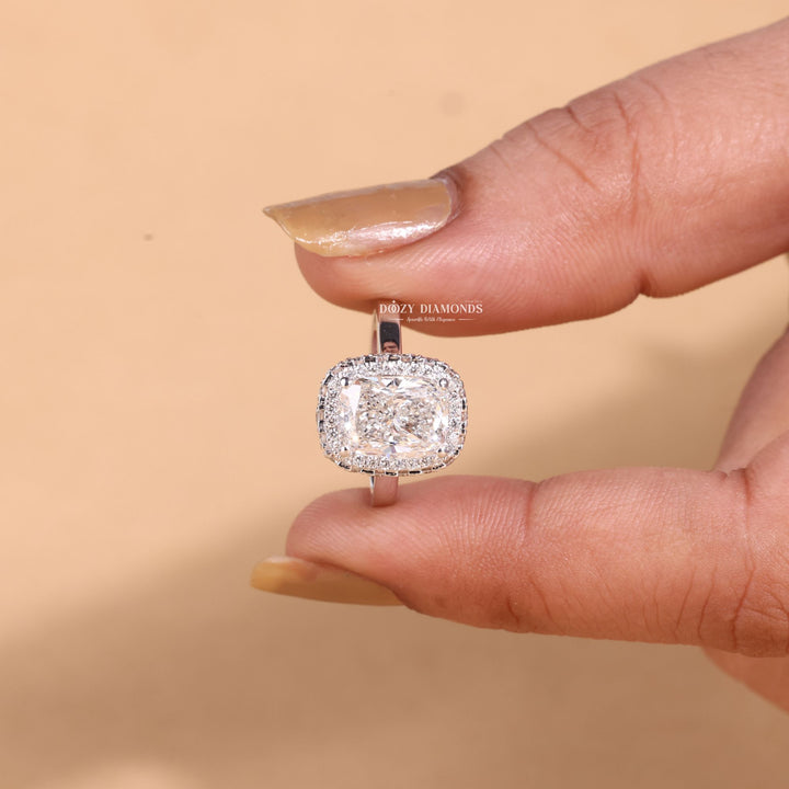 Macro shot of cushion cut diamond facets in halo ring setting