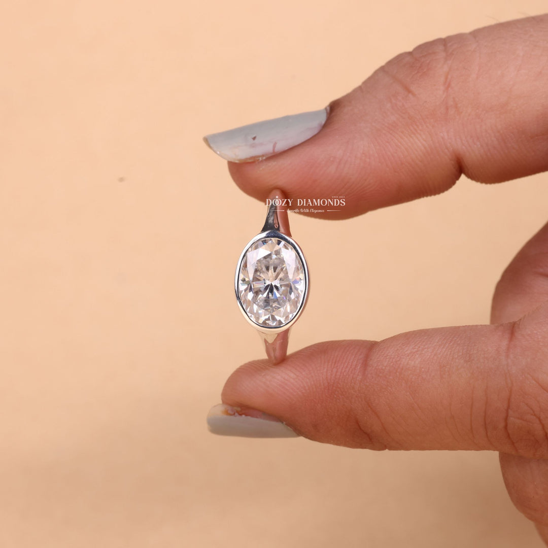 Oval cut east west engagement ring shown in real-life wear