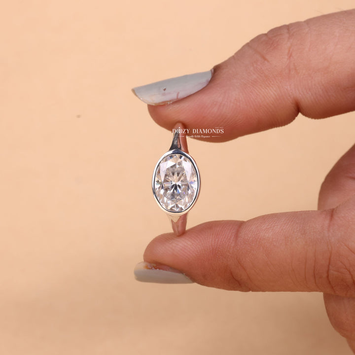 Oval cut east west engagement ring shown in real-life wear