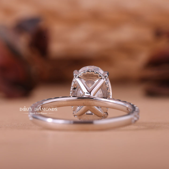 Close-up of oval cut center diamond in hidden halo engagement ring