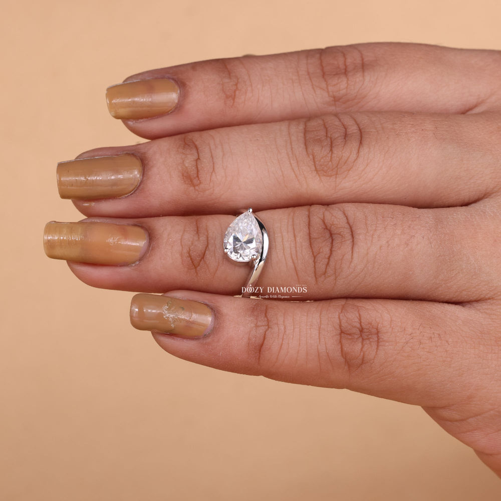 Pear solitaire diamond ring displayed on jewelry stand