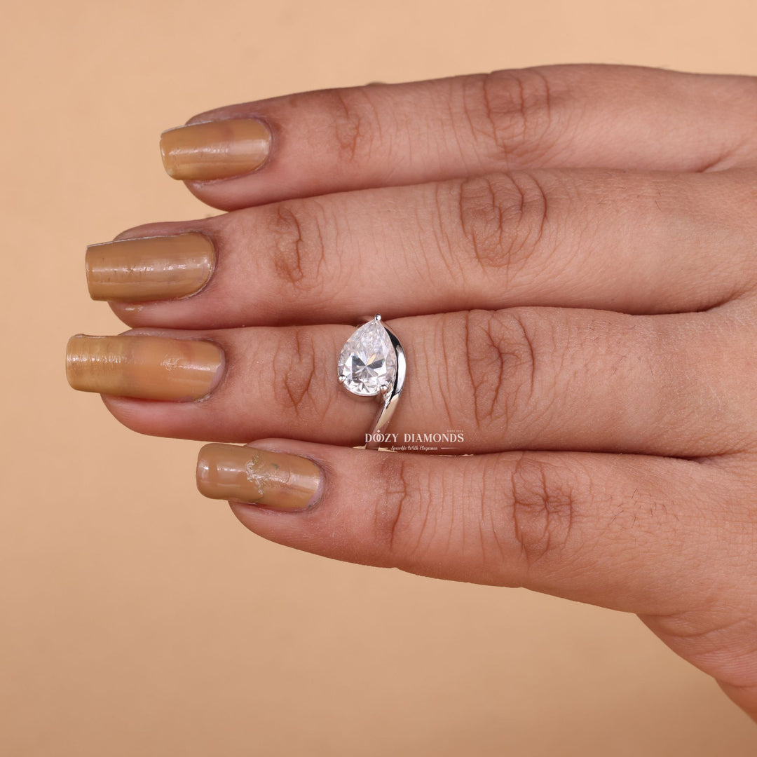 Pear solitaire diamond ring displayed on jewelry stand
