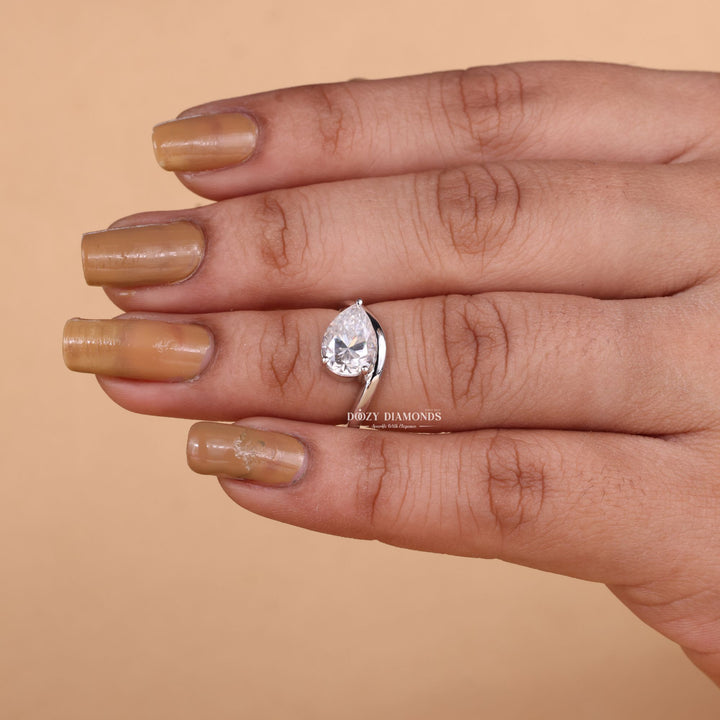 Pear solitaire diamond ring displayed on jewelry stand