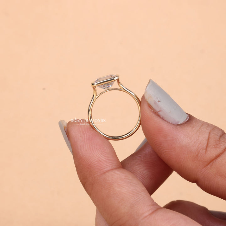 Emerald cut bezel engagement ring shown in real-life wear