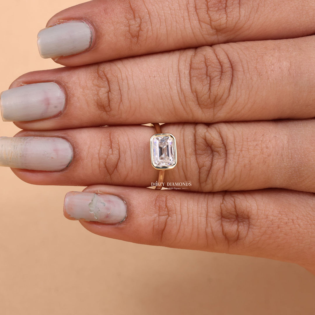 Lifestyle shot of emerald bezel diamond ring on hand