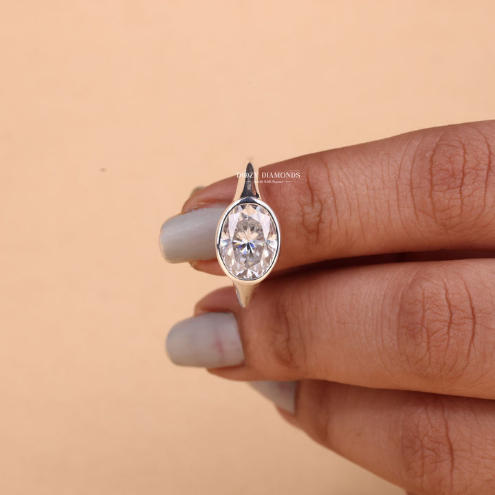 Oval cut east west engagement ring with IGI certified center diamond