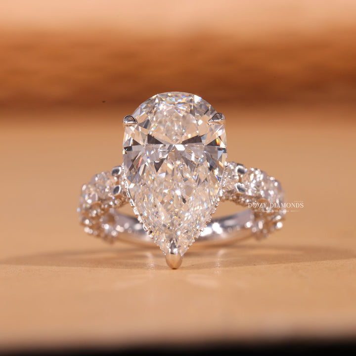 Detailed close-up of pear pave diamond engagement ring