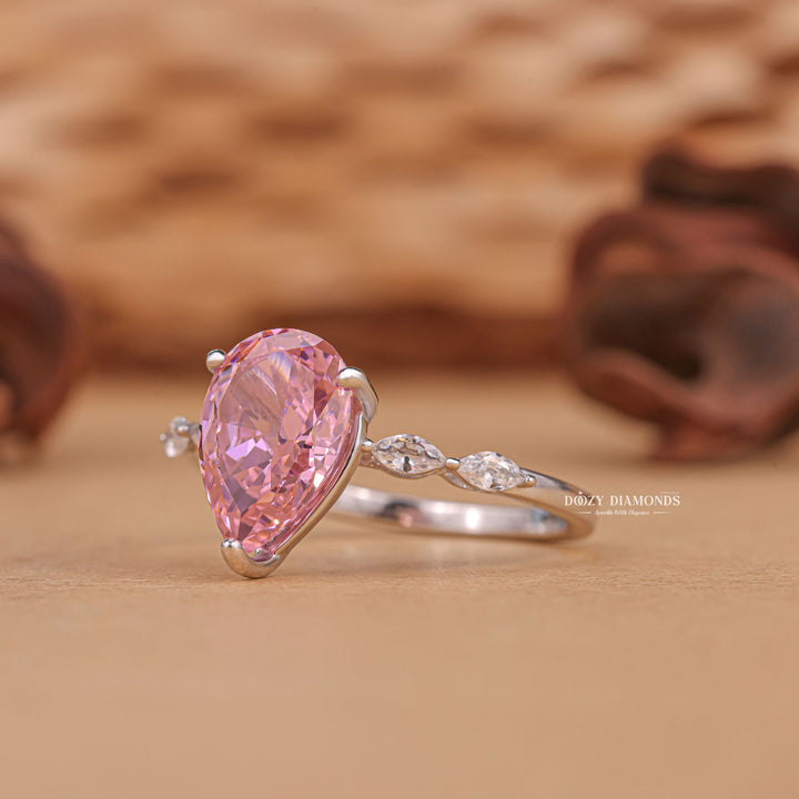 Detailed close-up of pear pave diamond engagement ring