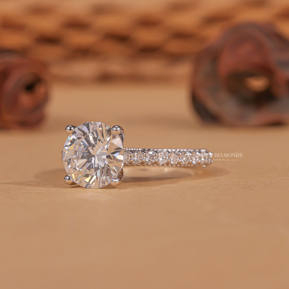 Round milgrain engagement ring offered in gold and platinum
