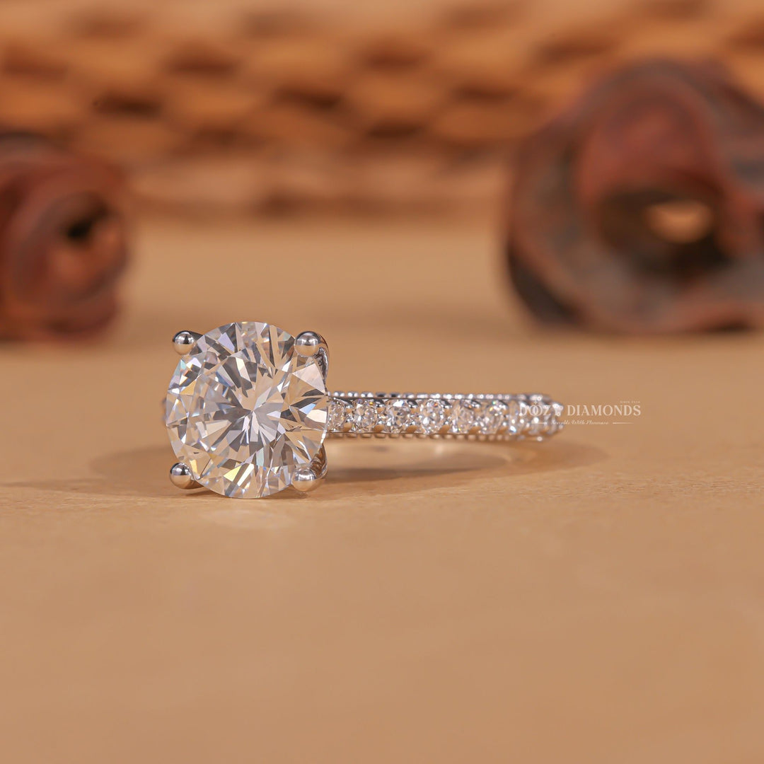 Round milgrain engagement ring offered in gold and platinum