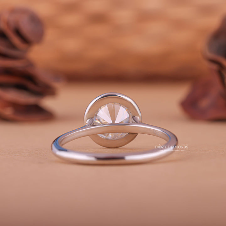 Round bezel diamond ring presented in signature gift packaging