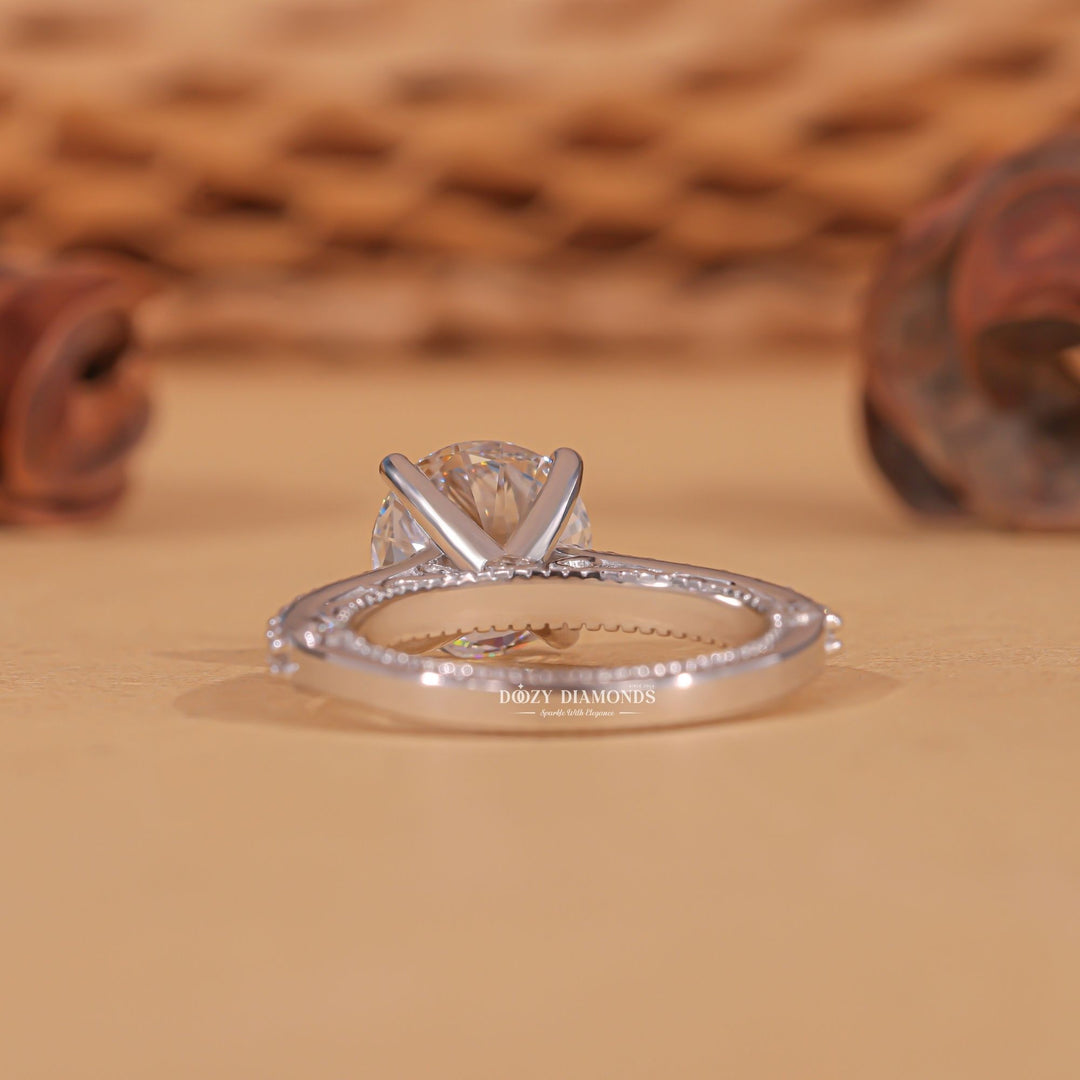 Round milgrain diamond ring presented in signature gift packaging