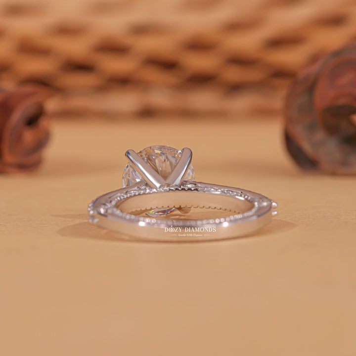 Round milgrain diamond ring presented in signature gift packaging