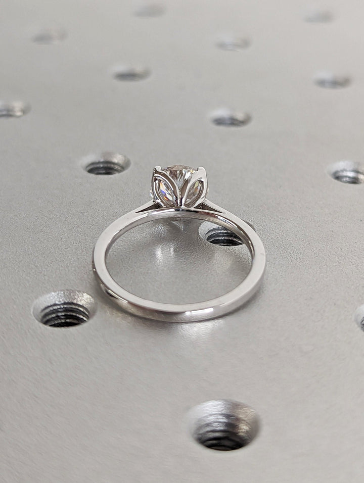 Close-up of round cut center diamond in solitaire engagement ring