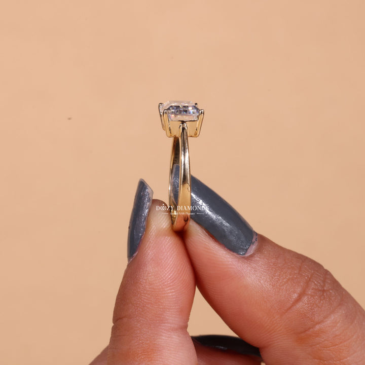 Detailed close-up of emerald east west diamond engagement ring
