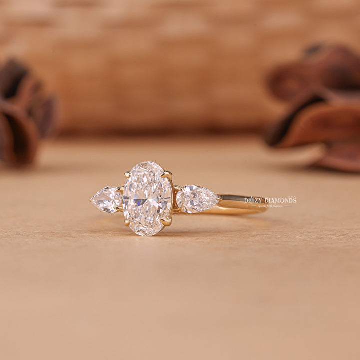 Lifestyle shot of oval three stone diamond ring on hand