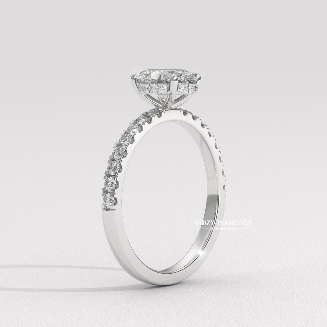 Oval hidden halo engagement ring photographed in natural light