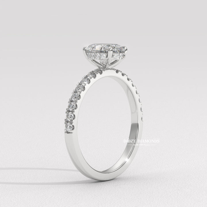 Oval hidden halo engagement ring photographed in natural light