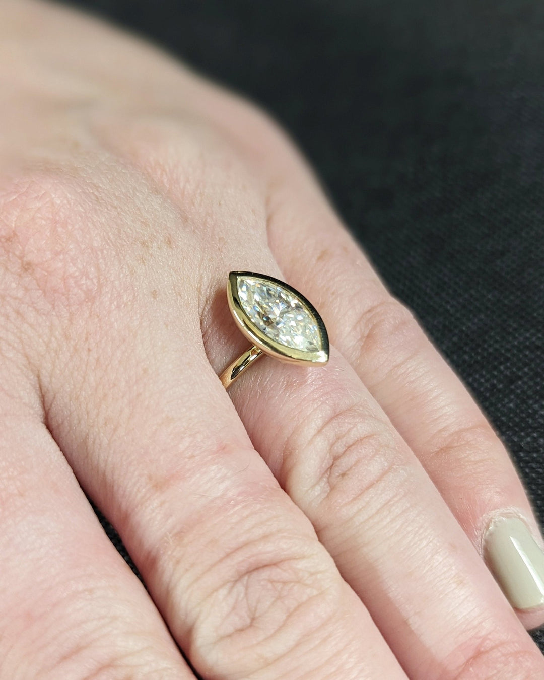 Marquise bezel engagement ring close-up showing high clarity diamond clarity