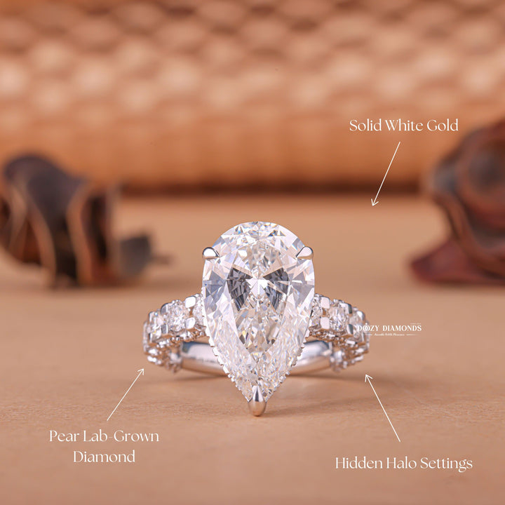 Pear hidden halo engagement ring shown on hand for true-to-life sizing