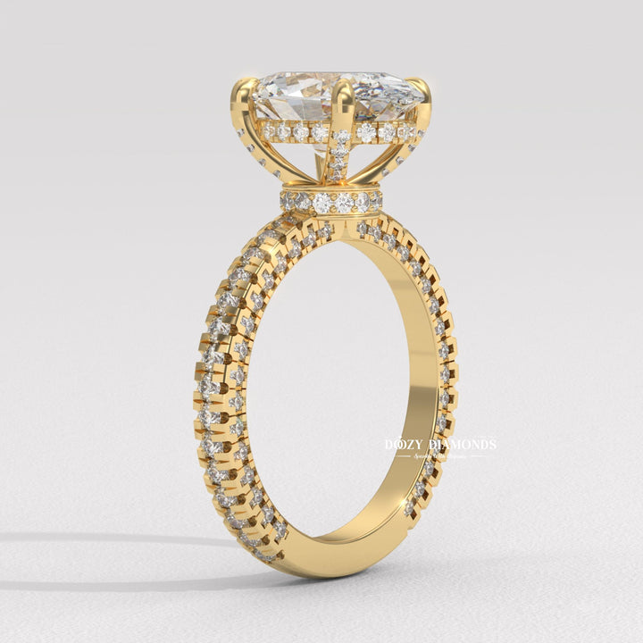 Close-up of oval cut center diamond in pave engagement ring