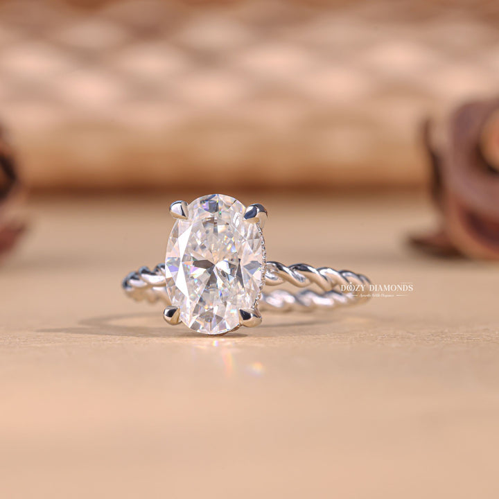 Detailed close-up of oval solitaire diamond engagement ring