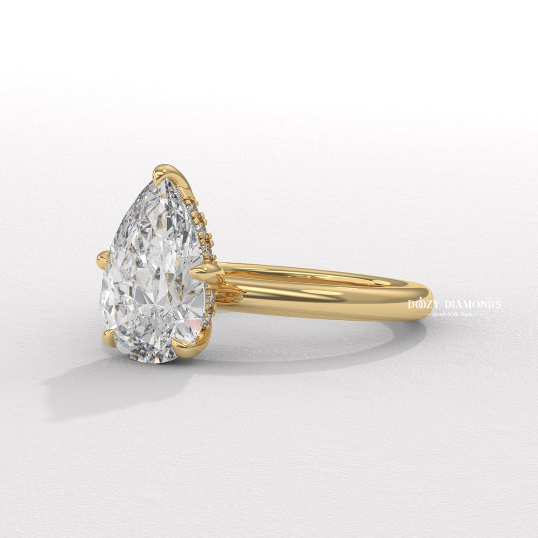 Pear cut engagement ring shown with authenticity certificate