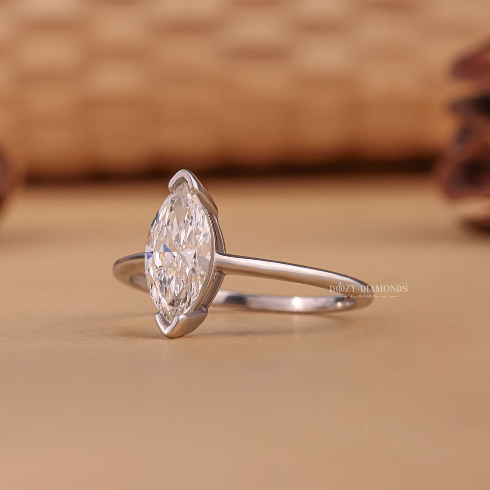 Detailed close-up of marquise solitaire diamond engagement ring