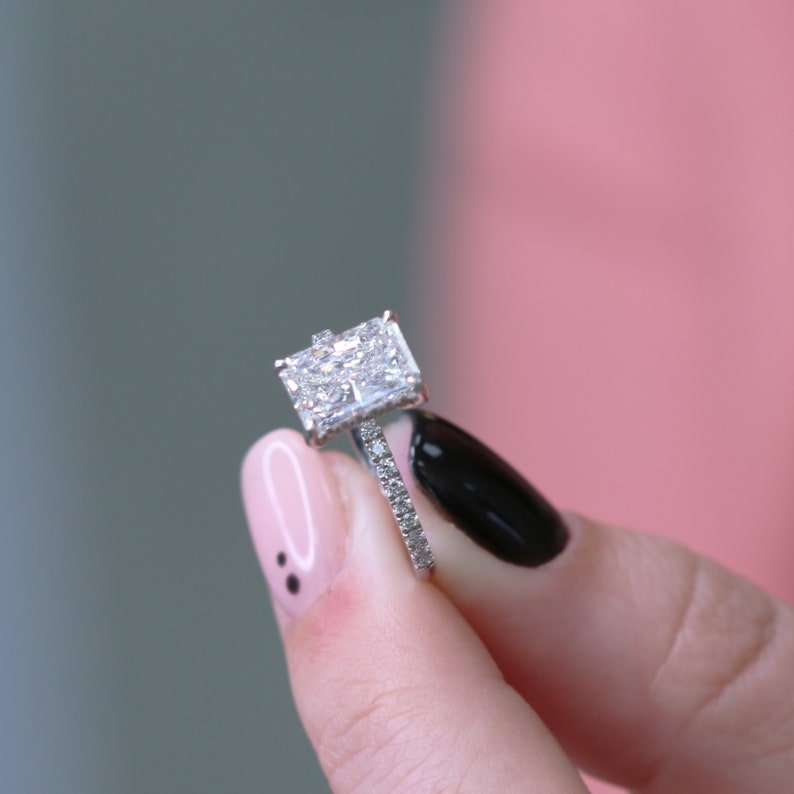 Side angle of radiant hidden halo diamond engagement ring