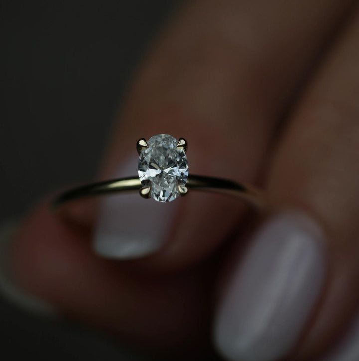 Angled view of oval cut diamond in solitaire setting