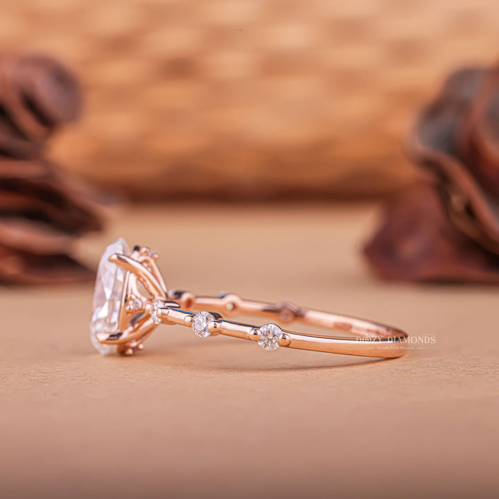 Close-up of oval cut center diamond in pave engagement ring